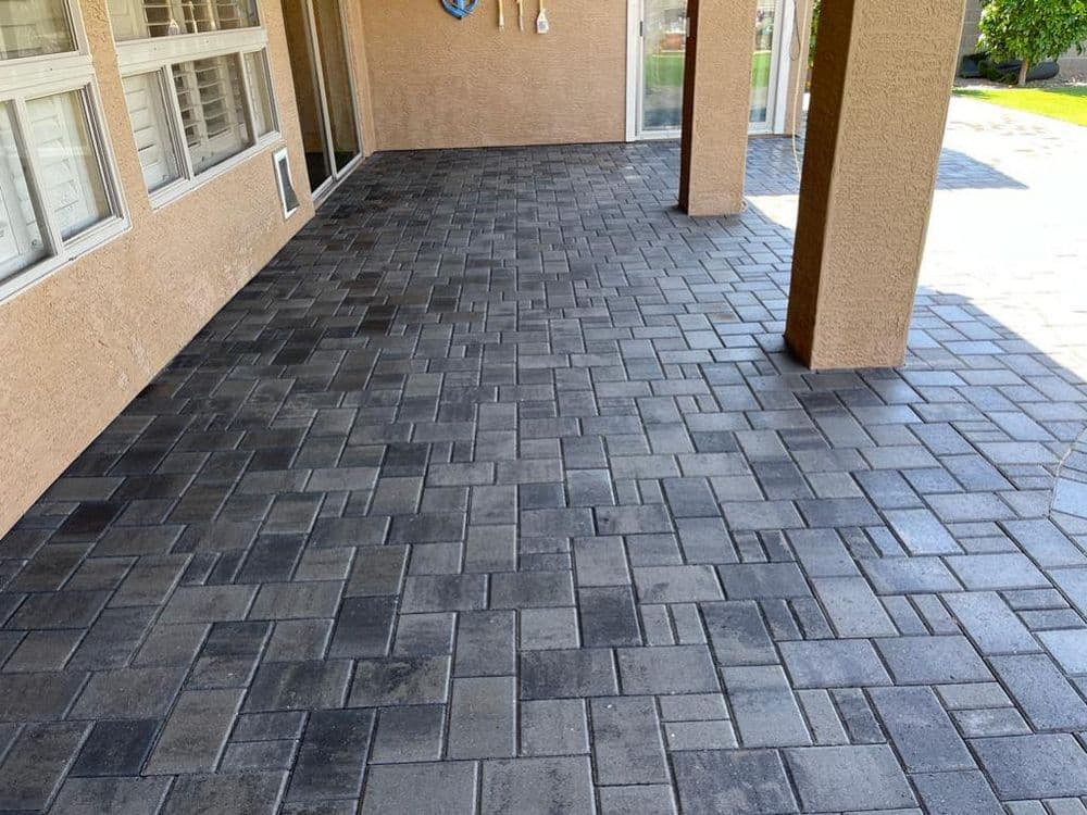 Modern paver patio flooring in gray tones, showcasing a spacious outdoor area.
